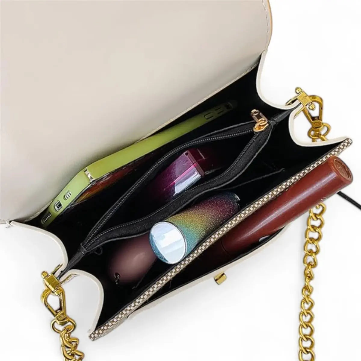 Interior da Bolsa Esmeralda Dourada, bolsa feminina pequena transversal com compartimentos organizados.