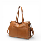 Bolsa de couro feminina Eliana marrom, vista lateral, com alça reforçada e design sofisticado.