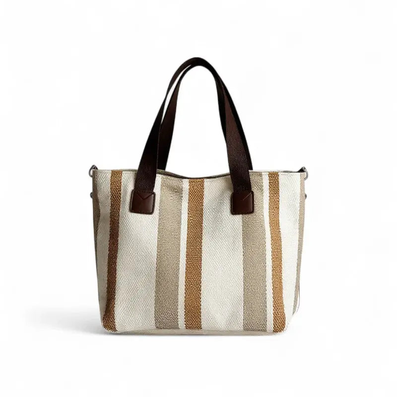Bolsa feminina transversal em tons neutros com listras em bege, marrom e creme. Design elegante e versátil para looks casuais ou trabalhistas.